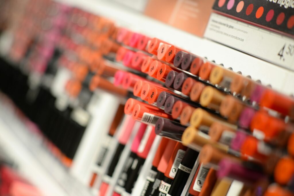 beauty fashion background shop 1571585 1571585 Close-up of diverse lipsticks in a store showcasing various shades and brands for beauty enthusiasts.